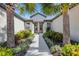 Inviting front entrance with beautiful landscaping and a paved walkway leading to the home's doorway at 5985 Amberly Dr, Bradenton, FL 34208
