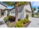 Attractive exterior view of home showcasing verdant landscaping, including a palm tree, and an attached two-car garage at 5985 Amberly Dr, Bradenton, FL 34208