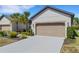 Charming single-Gathering home featuring a two-car garage, well-maintained landscaping, and a paved driveway at 5985 Amberly Dr, Bradenton, FL 34208