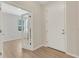Bright foyer featuring wood-look flooring and a view into a room through glass-paned french doors at 5985 Amberly Dr, Bradenton, FL 34208