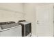 Well lit laundry room features a side-by-side washer and dryer and a wire shelf at 5985 Amberly Dr, Bradenton, FL 34208