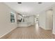 Open-concept living area showcasing wood-look floors that connect the kitchen and other living spaces at 5985 Amberly Dr, Bradenton, FL 34208