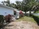 Landscaped backyard featuring beautiful bougainvillea and well-maintained hedges at 6074 Arlene Way # 5, Bradenton, FL 34207