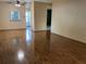 Open living room with laminate flooring and access to other rooms in the home at 6074 Arlene Way # 5, Bradenton, FL 34207