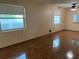 Bright living room with wood-look flooring, ceiling fan, and windows at 6074 Arlene Way # 5, Bradenton, FL 34207