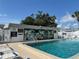 Community pool featuring an inviting blue water and mural on the pool house at 6074 Arlene Way # 5, Bradenton, FL 34207