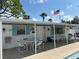 Poolside patio area with outdoor seating and American flag at 6074 Arlene Way # 5, Bradenton, FL 34207