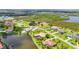Overhead aerial shot showing a home with a swimming pool surrounded by a green lawn and pond at 6143 9Th Avenue Ne Cir, Bradenton, FL 34212