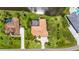Bird's eye view featuring a home with mature landscaping, paver driveway, and a screened-in pool near a pond at 6143 9Th Avenue Ne Cir, Bradenton, FL 34212