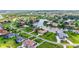 High angle view of neighborhood homes with manicured lawns and lush tropical landscaping near a waterway at 6143 9Th Avenue Ne Cir, Bradenton, FL 34212