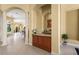 Elegant bar area with granite countertops, wood cabinetry, and decorative columns at 6143 9Th Avenue Ne Cir, Bradenton, FL 34212