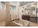 A luxurious bathroom features a tiled spa tub, walk in shower and dual sinks at 6143 9Th Avenue Ne Cir, Bradenton, FL 34212