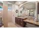 A bright bathroom offers dual sinks and large arched mirrors at 6143 9Th Avenue Ne Cir, Bradenton, FL 34212