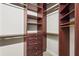 The walk-in closet features custom wood shelving and ample space at 6143 9Th Avenue Ne Cir, Bradenton, FL 34212
