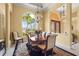 Home dining room with neutral walls, a decorative chandelier, arched windows, and decorative window molding at 6143 9Th Avenue Ne Cir, Bradenton, FL 34212