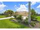Beautiful home featuring a tile roof, mature landscaping, and a circular driveway to the attached three-car garage at 6143 9Th Avenue Ne Cir, Bradenton, FL 34212