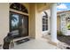 Close up on the home's front door with glass inserts, sidelight windows, and a tiled porch and walkway at 6143 9Th Avenue Ne Cir, Bradenton, FL 34212