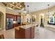 Spacious kitchen features stainless steel appliances, wood cabinetry and a large island for entertaining at 6143 9Th Avenue Ne Cir, Bradenton, FL 34212