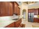 Close up of the wood cabinetry and granite countertops in the kitchen area with stainless steel appliances at 6143 9Th Avenue Ne Cir, Bradenton, FL 34212