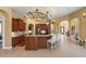 Open kitchen boasts wood cabinetry, granite countertops, tiled floors and pendant lighting over the island at 6143 9Th Avenue Ne Cir, Bradenton, FL 34212