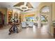 Spacious living room with neutral walls, tile floors, decorative columns, and outdoor views at 6143 9Th Avenue Ne Cir, Bradenton, FL 34212