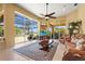 Spacious living room with large windows overlooking the pool and lake, providing abundant natural light at 6143 9Th Avenue Ne Cir, Bradenton, FL 34212