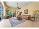 Bright living room features large windows, sliding glass doors, ceiling fan and access to the patio at 6143 9Th Avenue Ne Cir, Bradenton, FL 34212