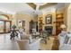 Open-concept living room with fireplace, decorative shelving, and stylish furniture at 6143 9Th Avenue Ne Cir, Bradenton, FL 34212
