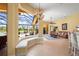 Living room with large window seat looking to the patio and pool area with an attached lounge at 6143 9Th Avenue Ne Cir, Bradenton, FL 34212