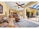 Spacious living room with tile floors and a seamless transition to the outdoor patio and pool at 6143 9Th Avenue Ne Cir, Bradenton, FL 34212