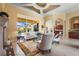 Inviting living room with a fireplace, large windows, and access to the outdoor living area at 6143 9Th Avenue Ne Cir, Bradenton, FL 34212