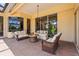 Covered patio with ceiling fan and comfortable seating for enjoying the outdoor space at 6143 9Th Avenue Ne Cir, Bradenton, FL 34212