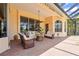Outdoor patio features comfortable seating, ceiling fan, and stone fire pit for entertaining at 6143 9Th Avenue Ne Cir, Bradenton, FL 34212