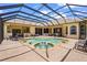 Enjoy this enclosed pool with lake view, brick patio and plenty of seating at 6143 9Th Avenue Ne Cir, Bradenton, FL 34212