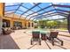 Enclosed pool area with lounge chairs, and tropical foliage provides the perfect relaxing space at 6143 9Th Avenue Ne Cir, Bradenton, FL 34212