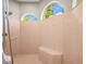 This walk-in shower is spacious and well lit with a built-in bench at 6143 9Th Avenue Ne Cir, Bradenton, FL 34212