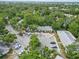 An aerial view of a condominium complex surrounded by lush trees and ample parking at 642 N Jefferson Ave # 13, Sarasota, FL 34237