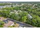 Bird's-eye view showcasing the property near a pond with plentiful mature trees surrounding the buildings at 642 N Jefferson Ave # 13, Sarasota, FL 34237