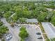 An aerial view of a condominium complex surrounded by lush trees and ample parking at 642 N Jefferson Ave # 13, Sarasota, FL 34237