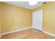 Cozy bedroom featuring hardwood floors, a ceiling light, and a double door closet at 642 N Jefferson Ave # 13, Sarasota, FL 34237