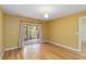 Bedroom featuring hardwood floors, neutral paint, and sliding doors to the screened patio at 642 N Jefferson Ave # 13, Sarasota, FL 34237