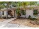 Charming home exterior with mature landscaping, a stone pathway and well-maintained garden beds at 642 N Jefferson Ave # 13, Sarasota, FL 34237