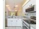 Well-appointed kitchen features stainless appliances, including range, microwave, and dishwasher at 642 N Jefferson Ave # 13, Sarasota, FL 34237