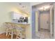 Bright kitchen and entrance featuring white cabinets, bar seating, and tile flooring at 642 N Jefferson Ave # 13, Sarasota, FL 34237