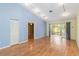 Open living space with hardwood floors, vaulted ceilings, and sliding glass doors to the patio at 642 N Jefferson Ave # 13, Sarasota, FL 34237