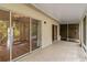 Tiled patio featuring sliding glass doors leading to the interior and screened-in area at 642 N Jefferson Ave # 13, Sarasota, FL 34237