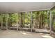 Screened in patio with tile flooring offering views of lush tropical backyard at 642 N Jefferson Ave # 13, Sarasota, FL 34237