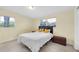 Bedroom with natural light, Terrazzo flooring, a double bed and yellow accent pillows at 6628 Auburn Ave, Bradenton, FL 34207