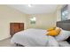 Bedroom with natural light, Terrazzo flooring, and yellow accent pillows at 6628 Auburn Ave, Bradenton, FL 34207