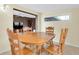 Traditional dining room featuring wood table and chairs, adjacent to living area, with Terrazzo tile flooring at 6628 Auburn Ave, Bradenton, FL 34207